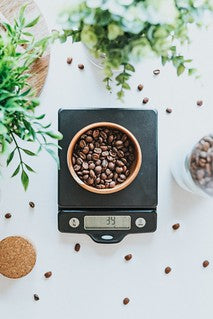 Weighing coffee beans on scales