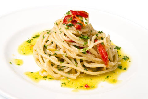aglio olio pasta on a white plate
