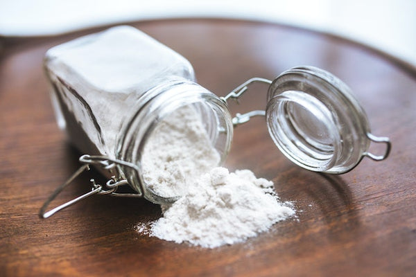 Baking soda on a jar on top of a wooden table