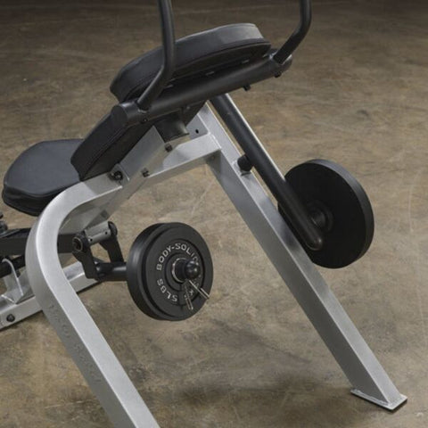 Body-Solid Semi-Recumbent Ab Bench adding weight plates for added intensity