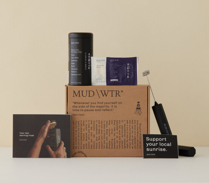 MUD\WTR product display with quotes on packaging, including a canister, packets, and a frother.