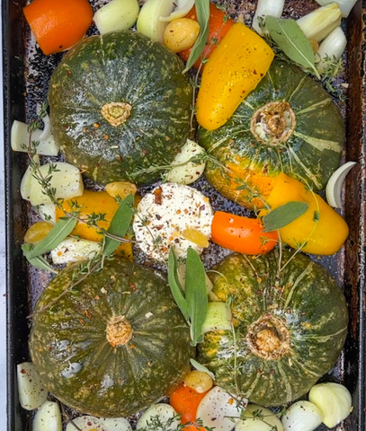 buttercup squash, carrots and boursin cheese on a roasting tray