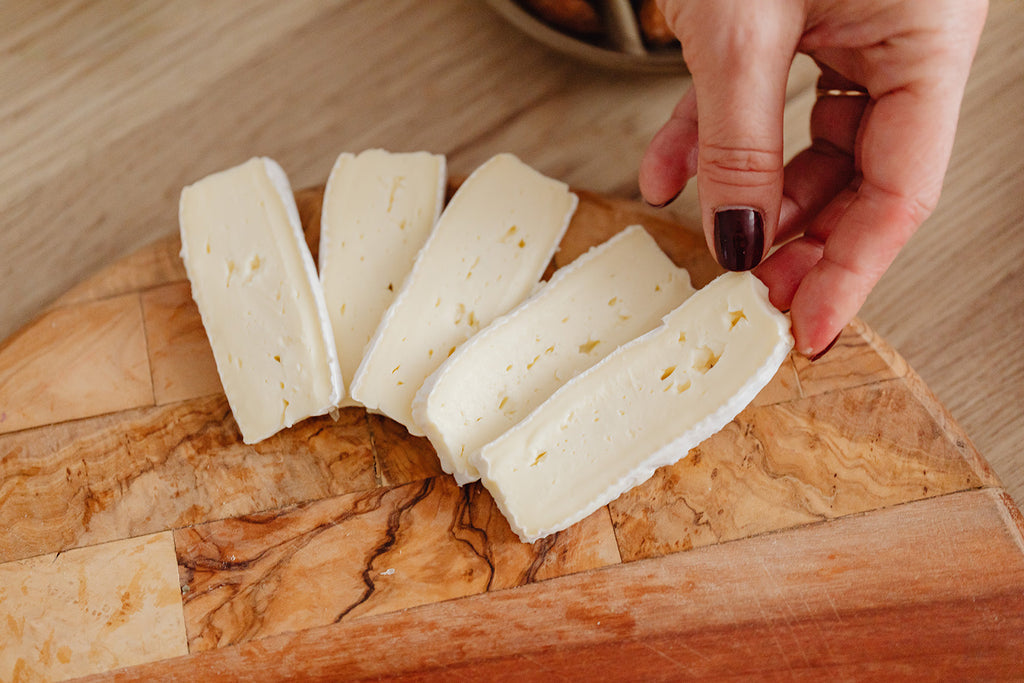 Close up of brie slices on a cheese board