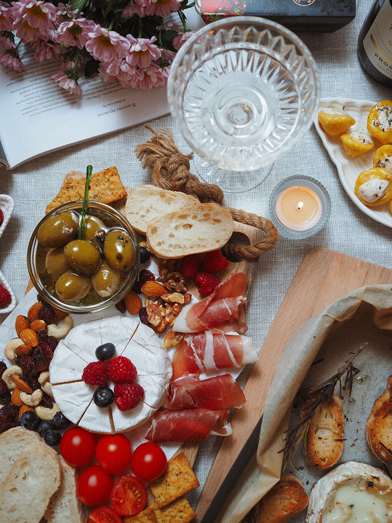 Charcuterie board of 4th of July with tomatoes, red-hued meats, and berries