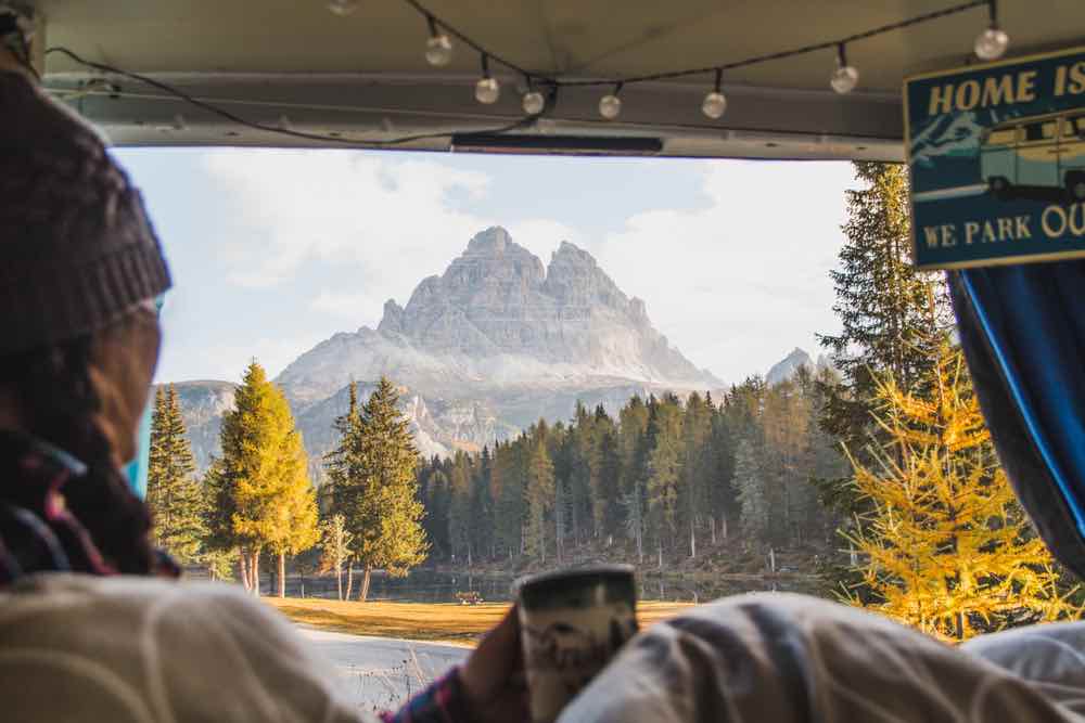 Woman in a van camping in the mountains