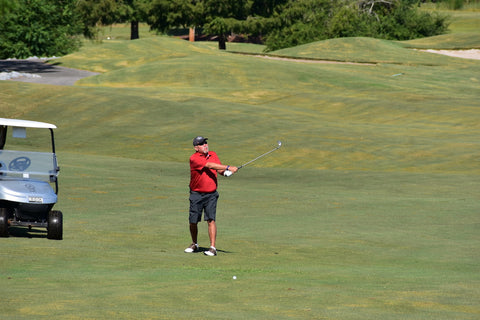 Action shot of a man hitting a golf shot.