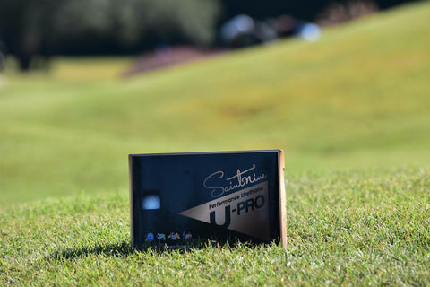 Image of a dozen Saintnine U-Pro golf balls in the grass.