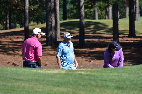 Image of golfers mid competition.