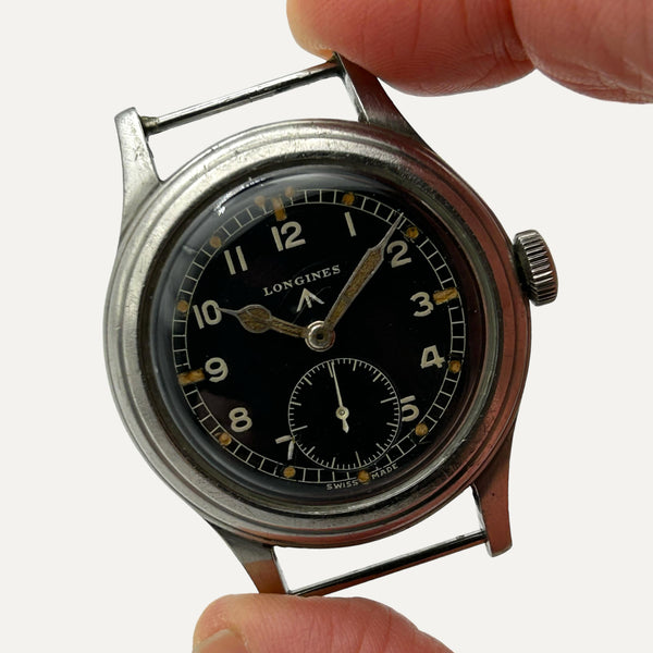 a longines military watch with a steel case, black dial, and no bracelets