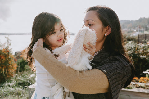 Mom, and Baby holding a special personalized gift 