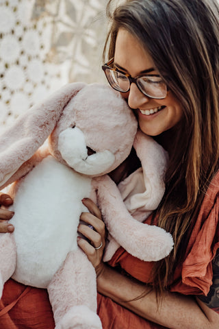 Woman Hugging Pink Stuffed Bunny