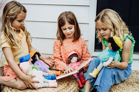 Girls Reading to Dolls