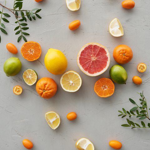 selection of citrus fruits on a grey background