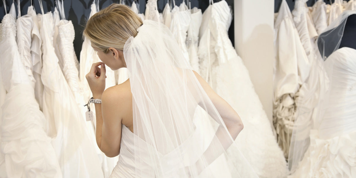 a bride is choosing the wedding dress
