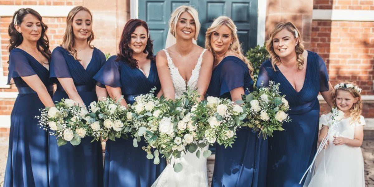 bridemaids in navy blue bridesmaid dresses