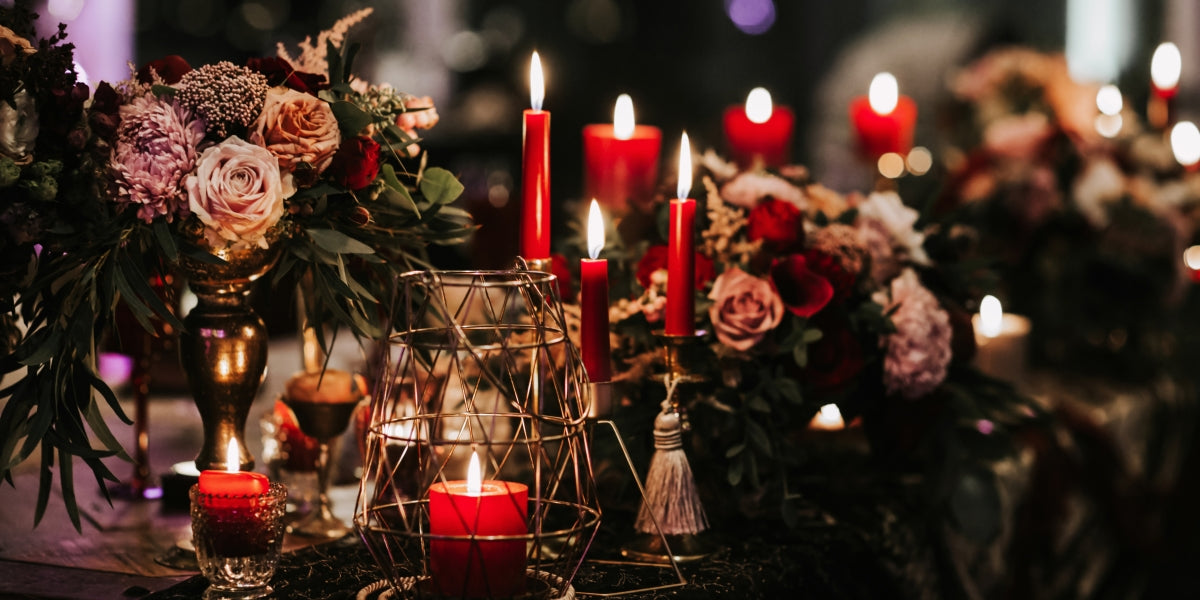 Beautiful, decorated table with flower decorations and red candles. Christmas evening or wedding party decoration.