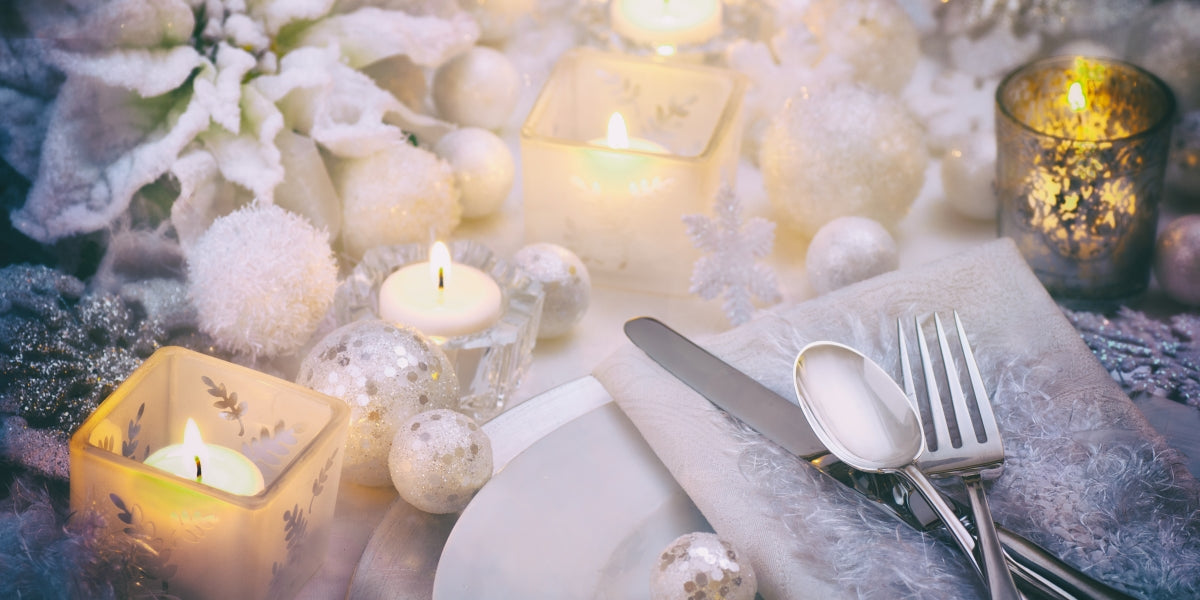 Frosty White Christmas Scene Table Place Setting with Poinsettia, Candles, Snowballs and Snowflakes with room or space for copy, text, your words. Horizontal, dramatic and moody dark vintage tones