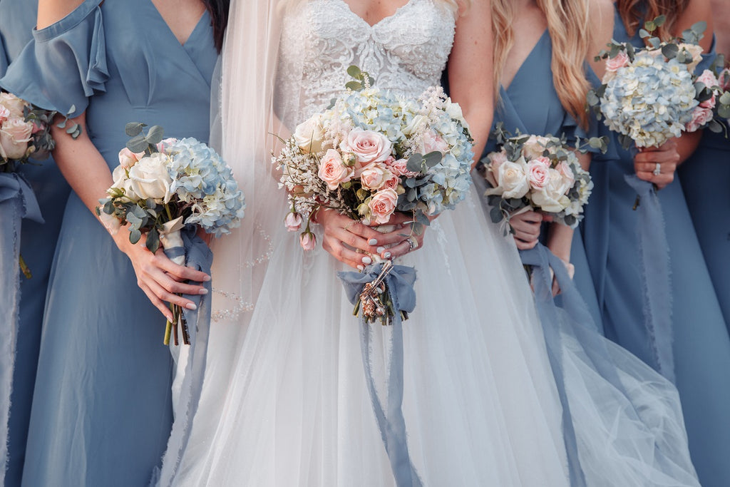 bride surrounded by bridesmaids in light blue