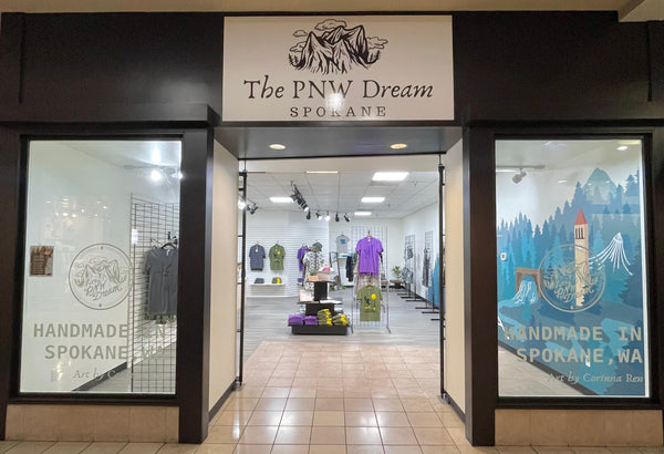 The PNW Dream Spokane store front with a view of some of the clothing inside.