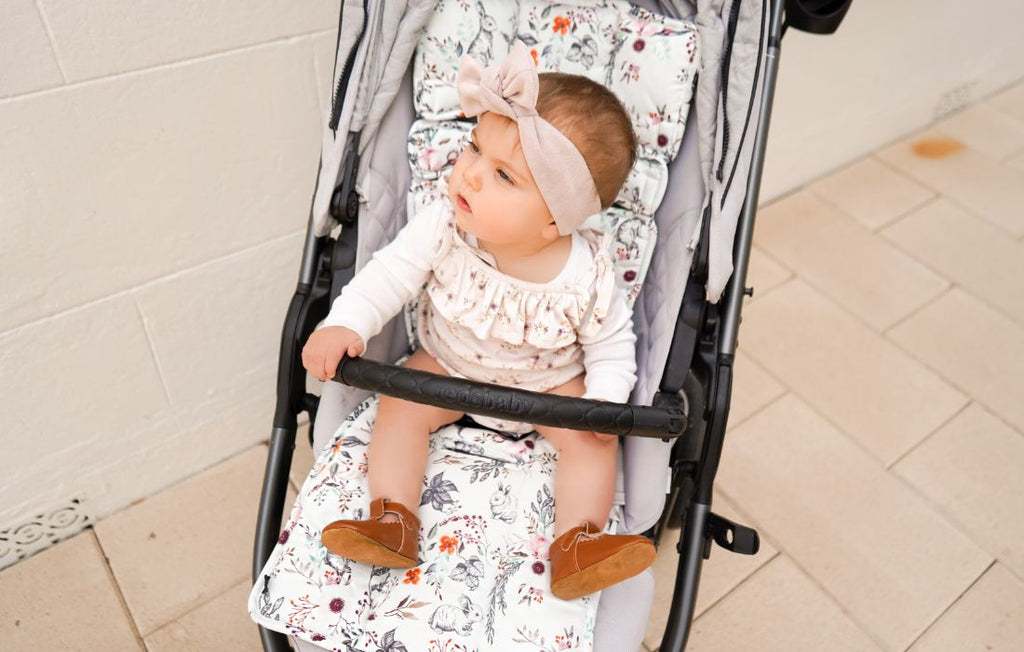 bub in pram with colourful pram liner