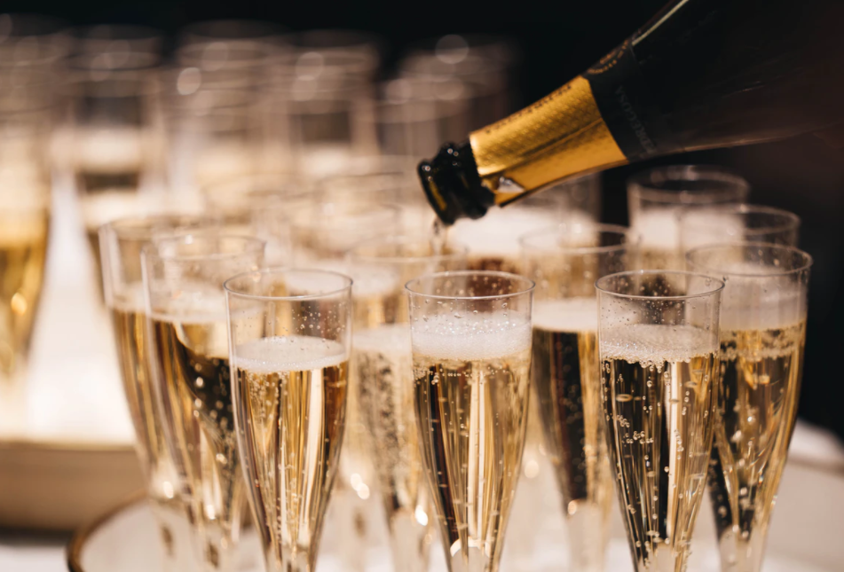 Champagne glasses being filled- Unsplash