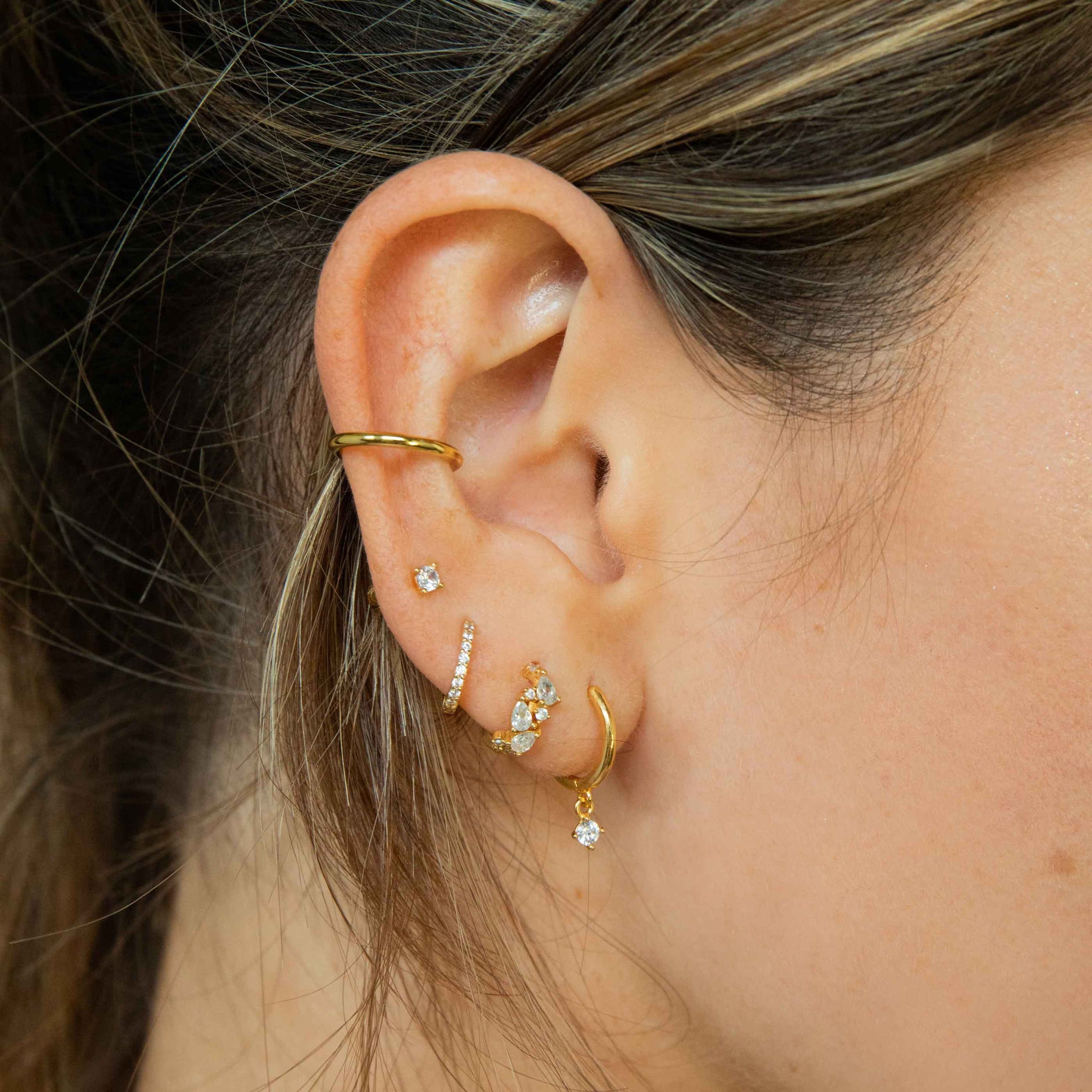 Worn shot of Crystal Jewelled Huggies in Gold in upper lobe piercing