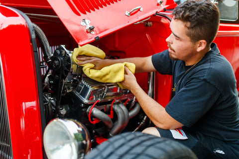 Wiping a clean engine bay down with a microfibre towel