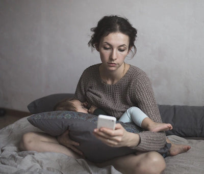 Worried woman breastfeeding her baby