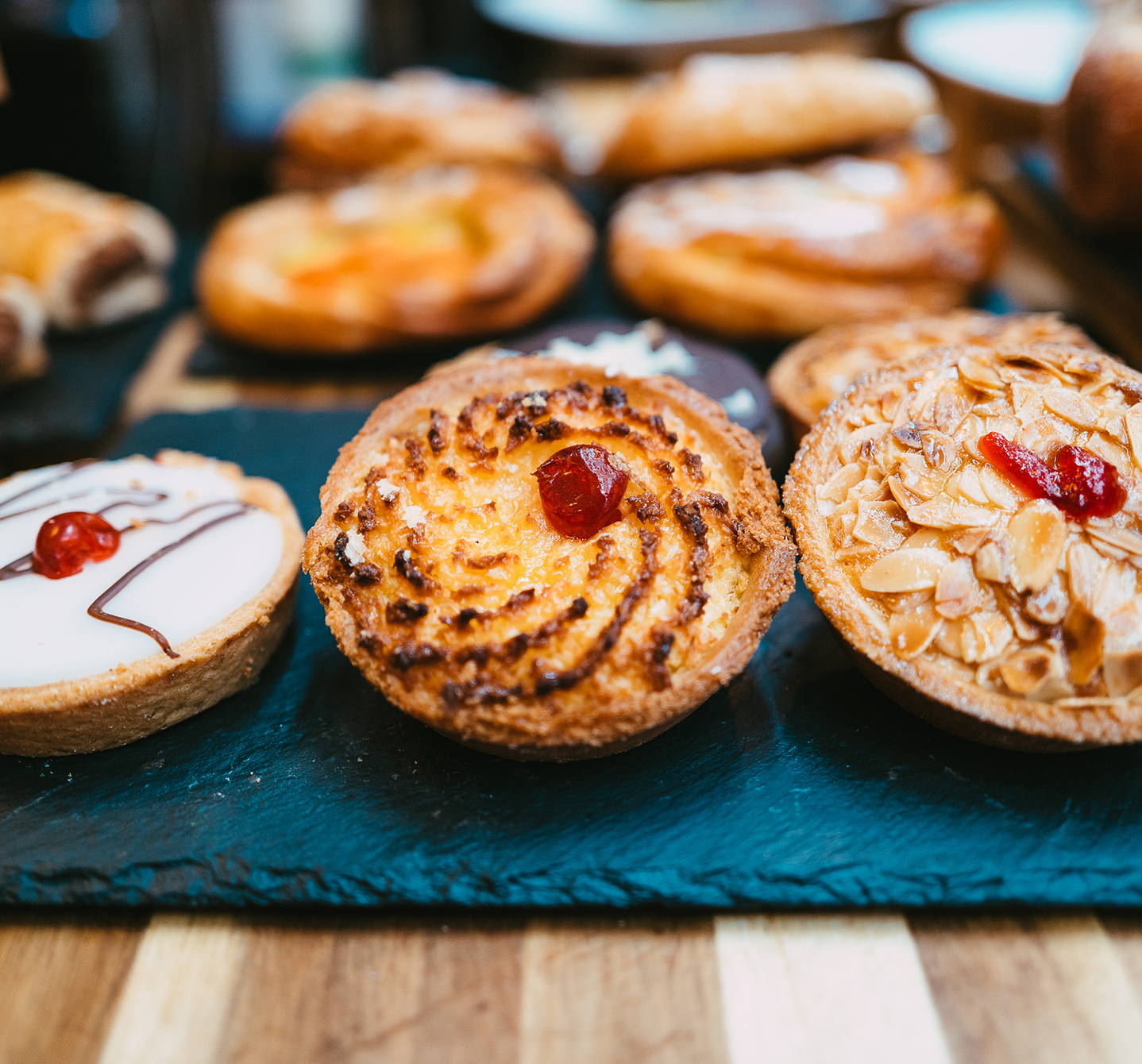 Row of delicious almond tarts with a cherry on top – one of the foods to avoid if you’ve got almond allergy