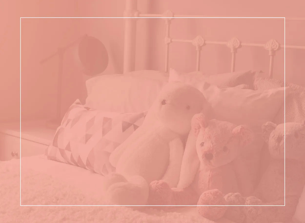 Teddies on bed in pink