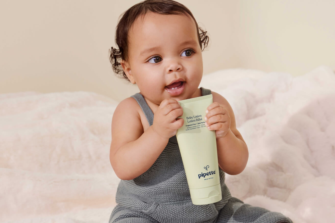 <p style="color:white;">Baby Holding Baby Lotion</p>