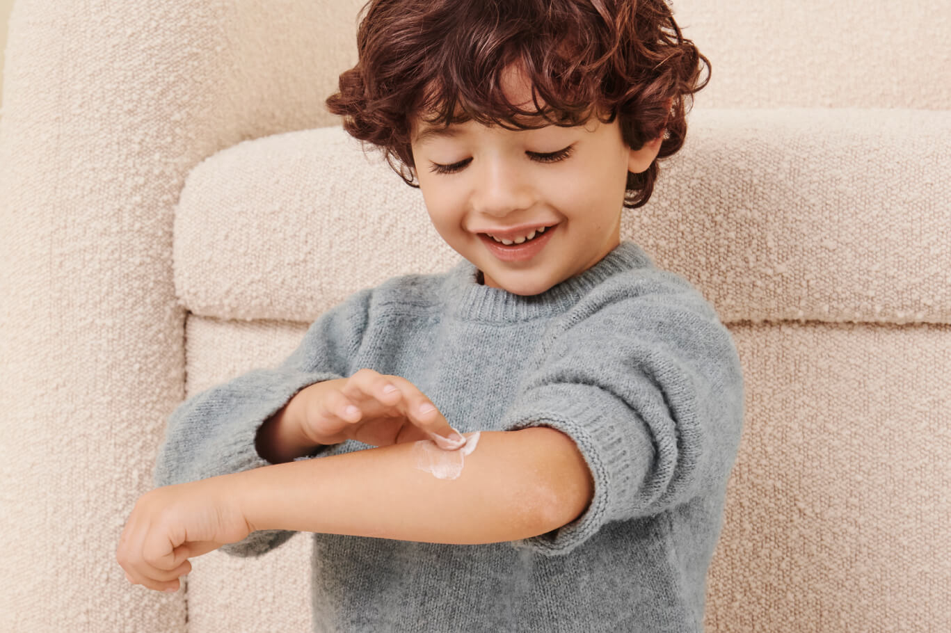 <p style="color:white;">Kid applying Eczema Lotion</p>