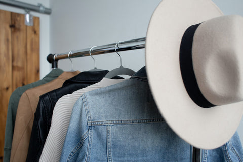 Beach hat hanging on clothing rack