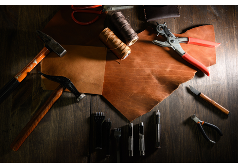 overhead shot of leather, leather tools and thread
