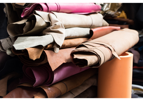 pile of leather rolls and scraps in different colours and textures
