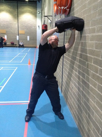 PC Daniel Sullivan, Specialist Trainer/ PTI at Bedfordshire Police puts a sandbag through its paces