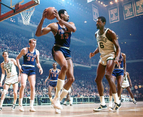 The 76ers Wilt Chamberlain plays against the Celtics Bill Russell