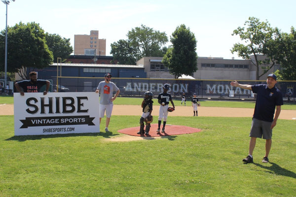 Coach Amos presents Reef and Johnny with the outfield banner during pregame festivities