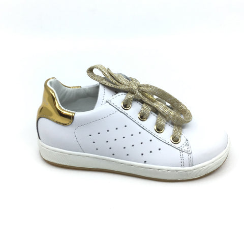 white sneakers with gold trim