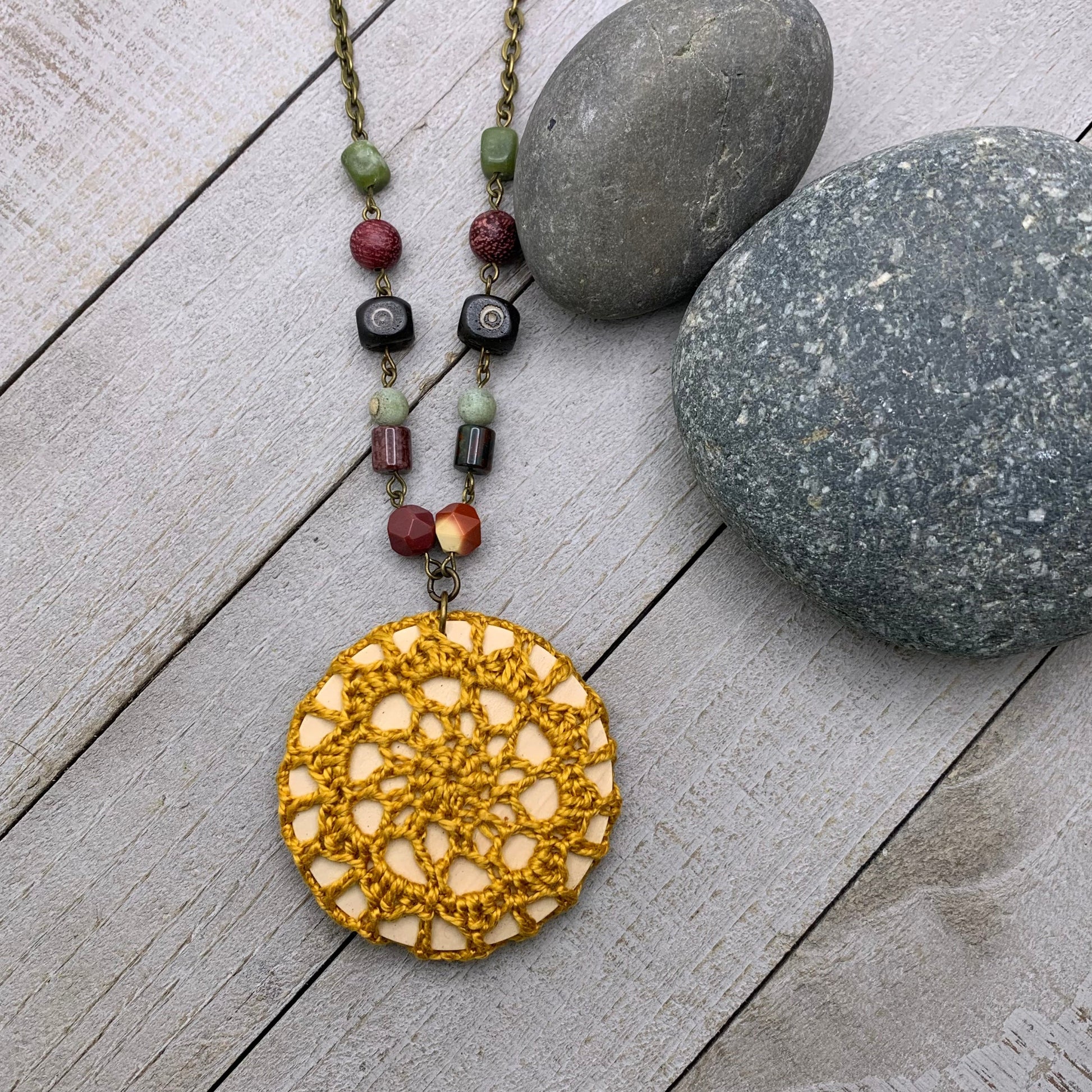 crocheted necklace with beaded chain in gold and antiqued brass