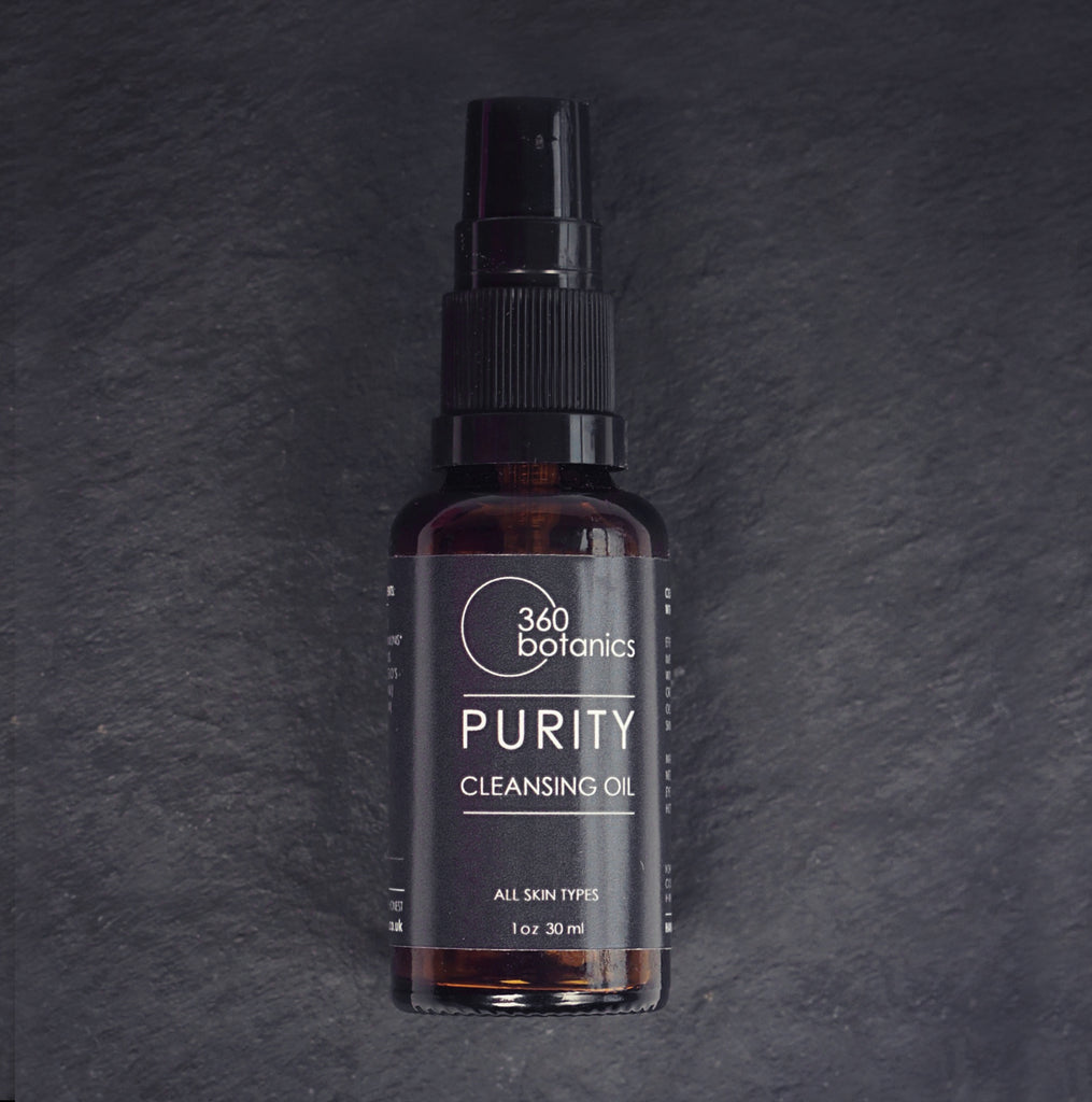 amber bottle on black slate background purity cleansing oil