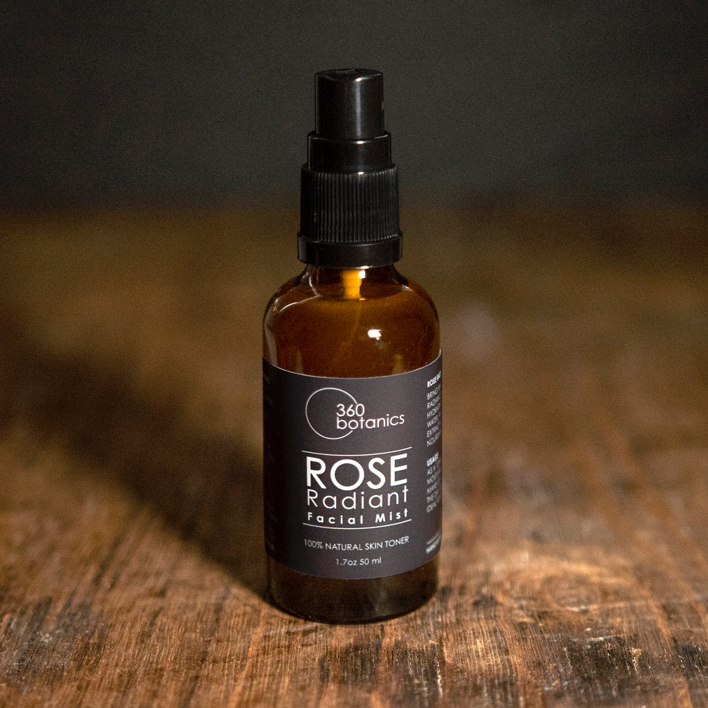 amber spray bottle of facial toner against an aged wood background