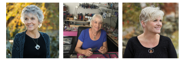 A woman modeling a pendant on the left; Jan smiling at the camera in the middle; another model on the right.