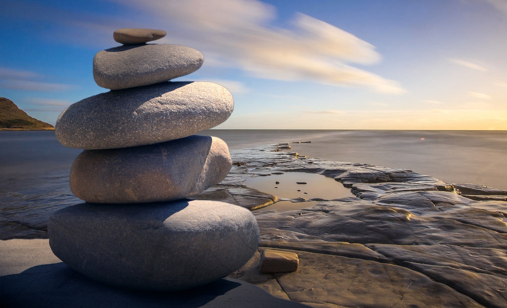 rocks stacked by body of water