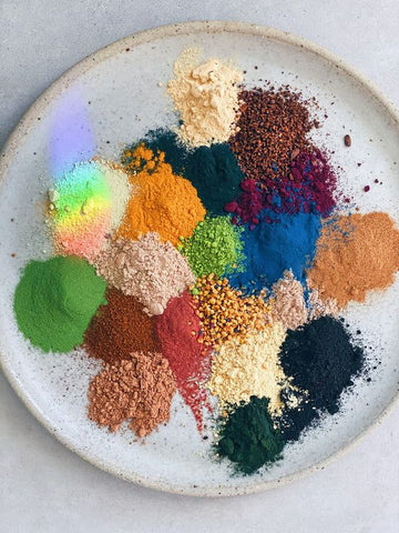 Photo of colourful powder adaptogens together on a plate