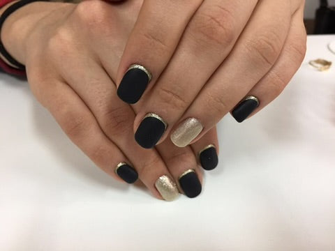 Russian manicure with black gel polish, silver metallic nail polish accents one nail on each hand with a line on other nails