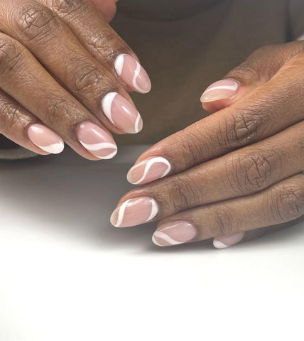 Pink and white nails created with gel nail polish