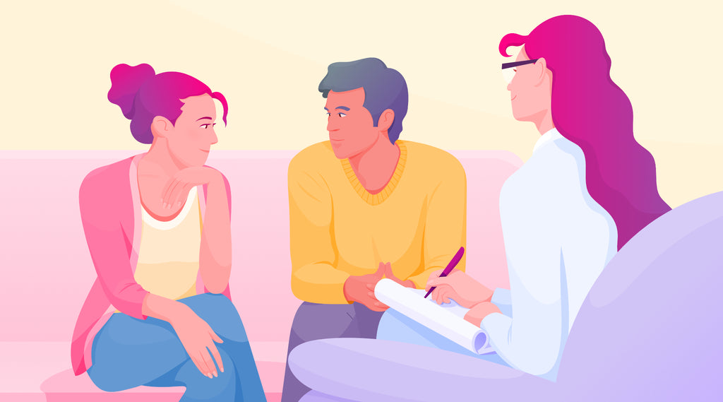 Young man and young woman facing one another in a therapy session with psychologist