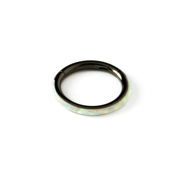 shiny black surgical steel clicker ring with white opal adorned its outer rim frontal view