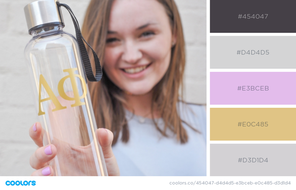 woman holding water bottle with Greek letters